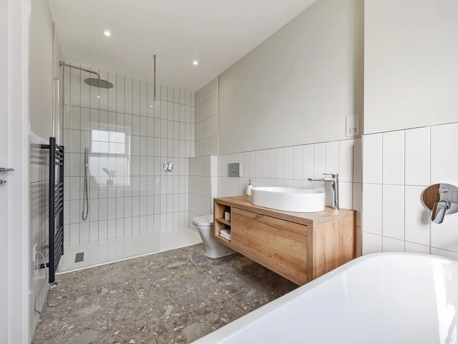 Ensuite bathroom with bath, overhead walk in shower, sink and WC.