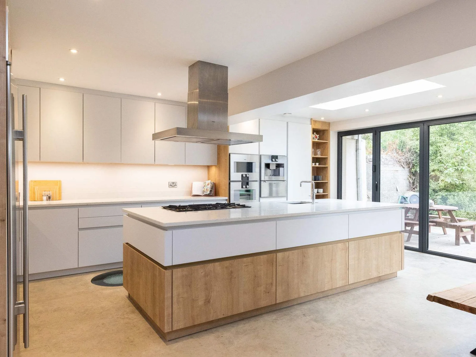 This large kitchen includes a centre island with hob and sink, perfect for cooking and entertaining.