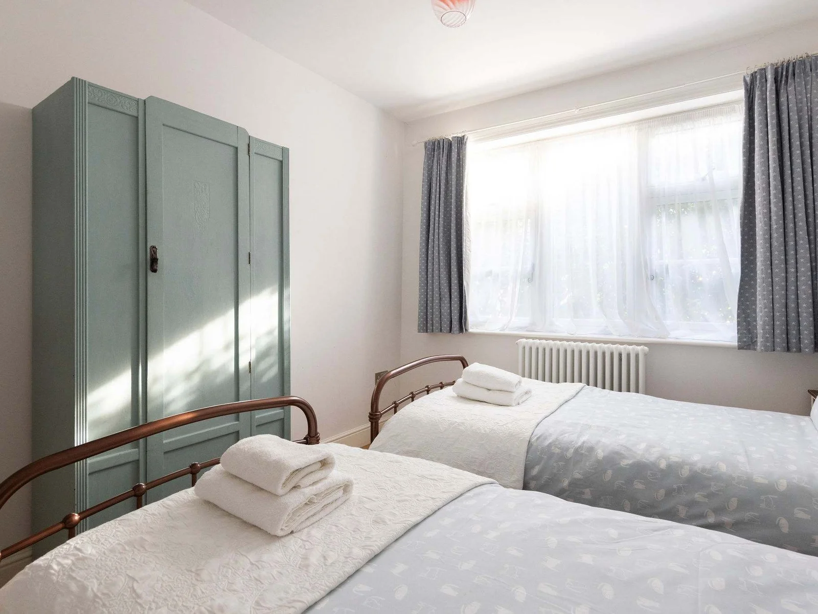 Lovely twin bedroom with wardrobe.