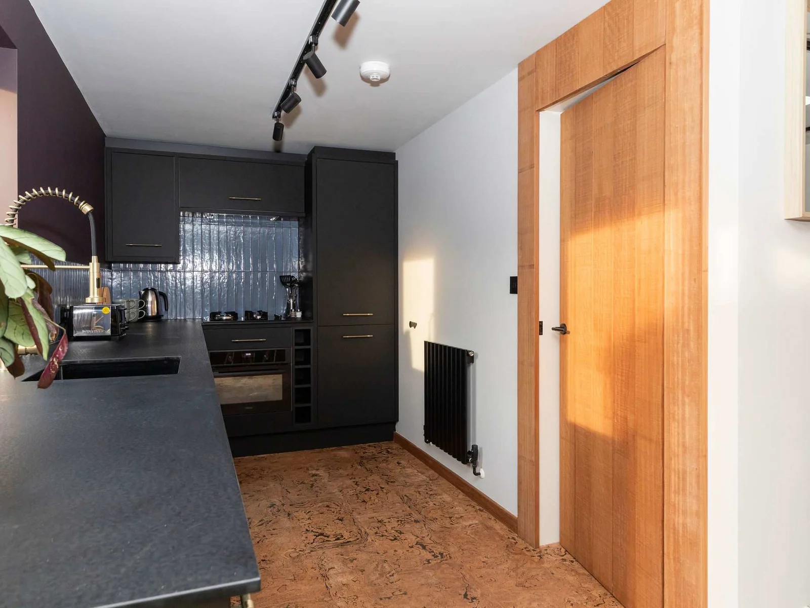 The black countertops and cabinetry give the kitchen a sleek, modern feel.