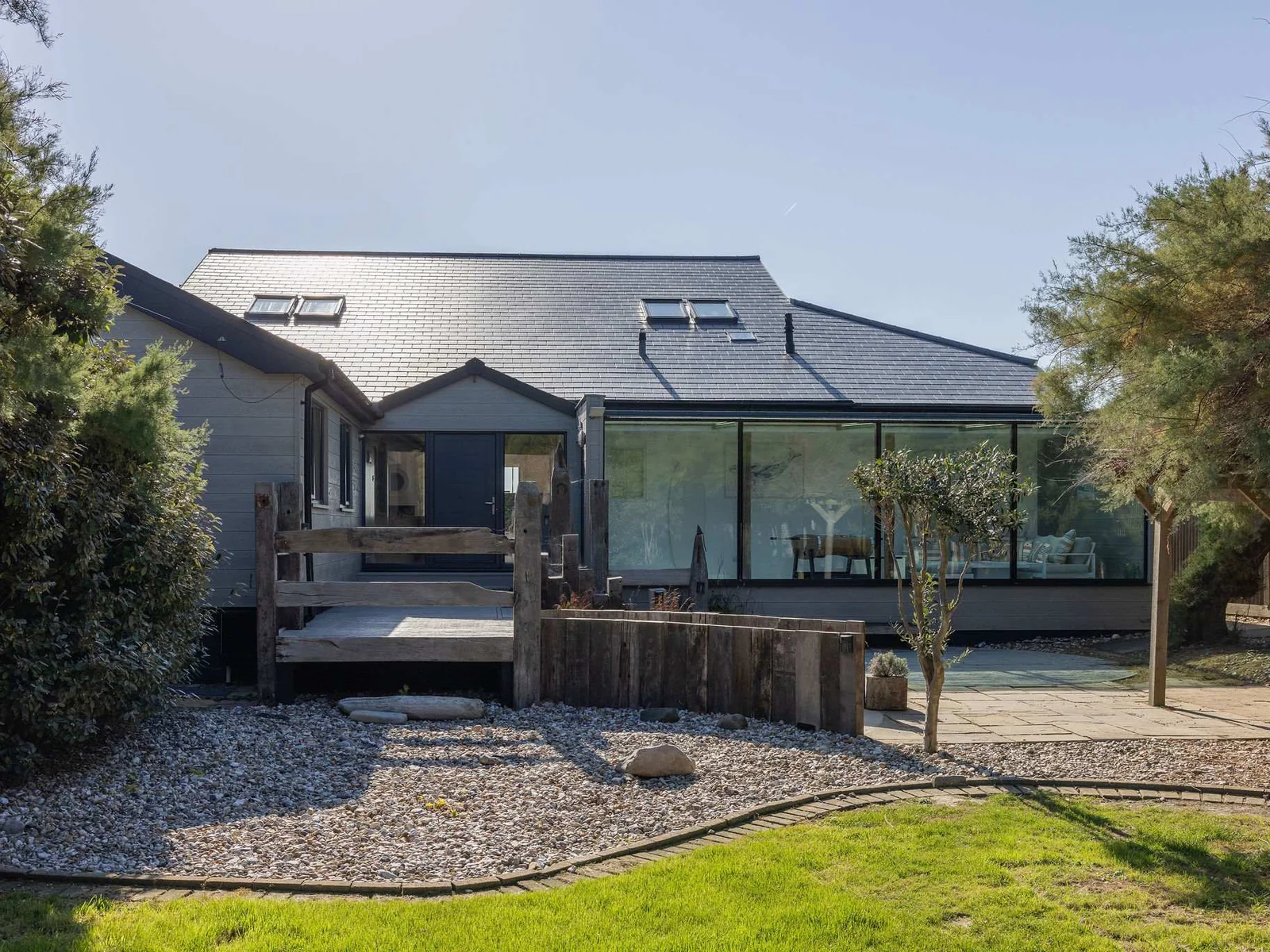 Once you park, enter the home via the landscaped front garden, lined with tamarisk trees and shingle path.