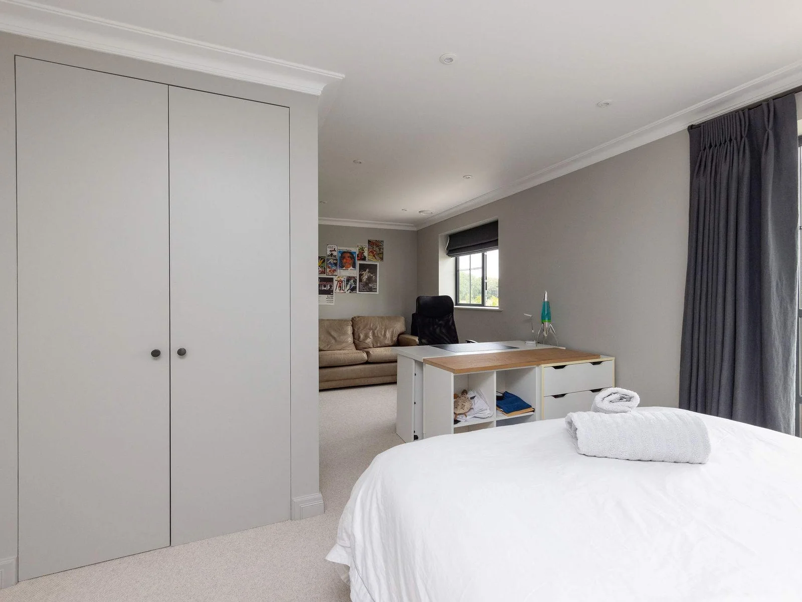 Spacious bedroom with desk and sofa bed