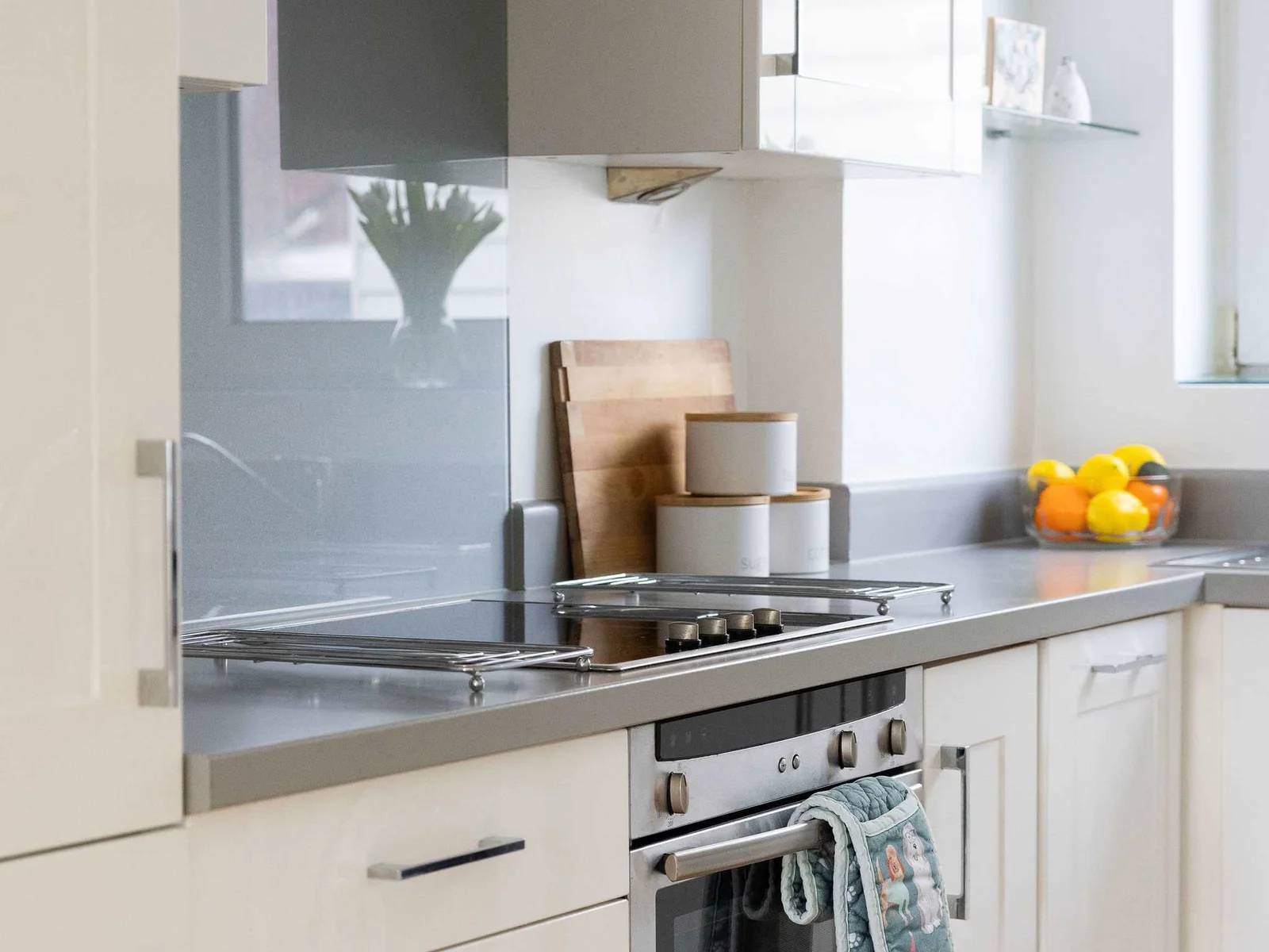 Well-equipped kitchen area with oven, hob, and ample storage, ideal for preparing delicious meals during your seaside getaway.