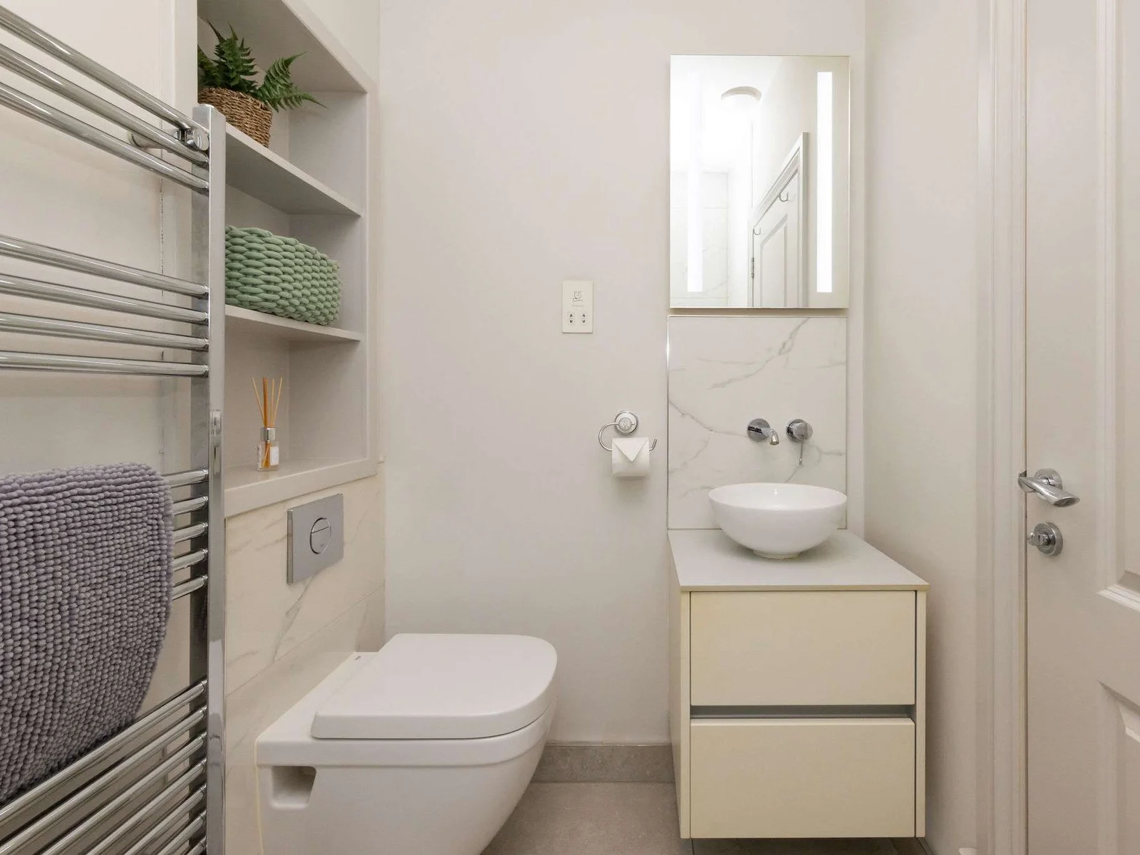 Modern bathroom spaces bring style and convenience to this seafront apartment.