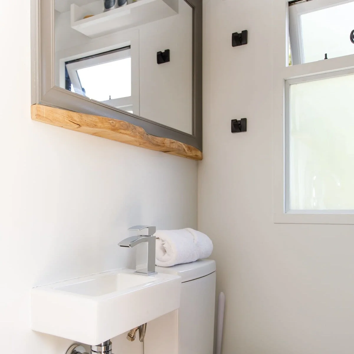 The bathroom has a flushing WC, sink, spacious shower, towels and soap.
