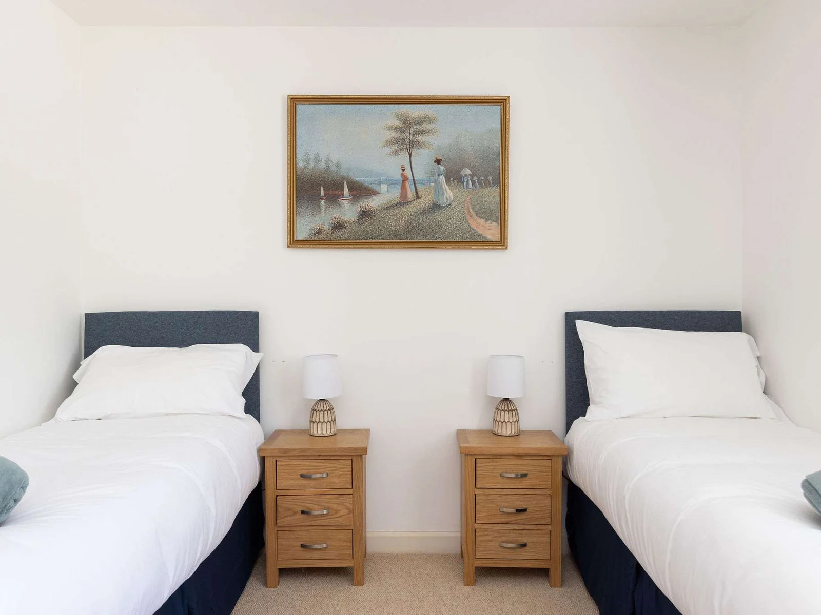 Twin bedroom with matching side tables and soft lighting