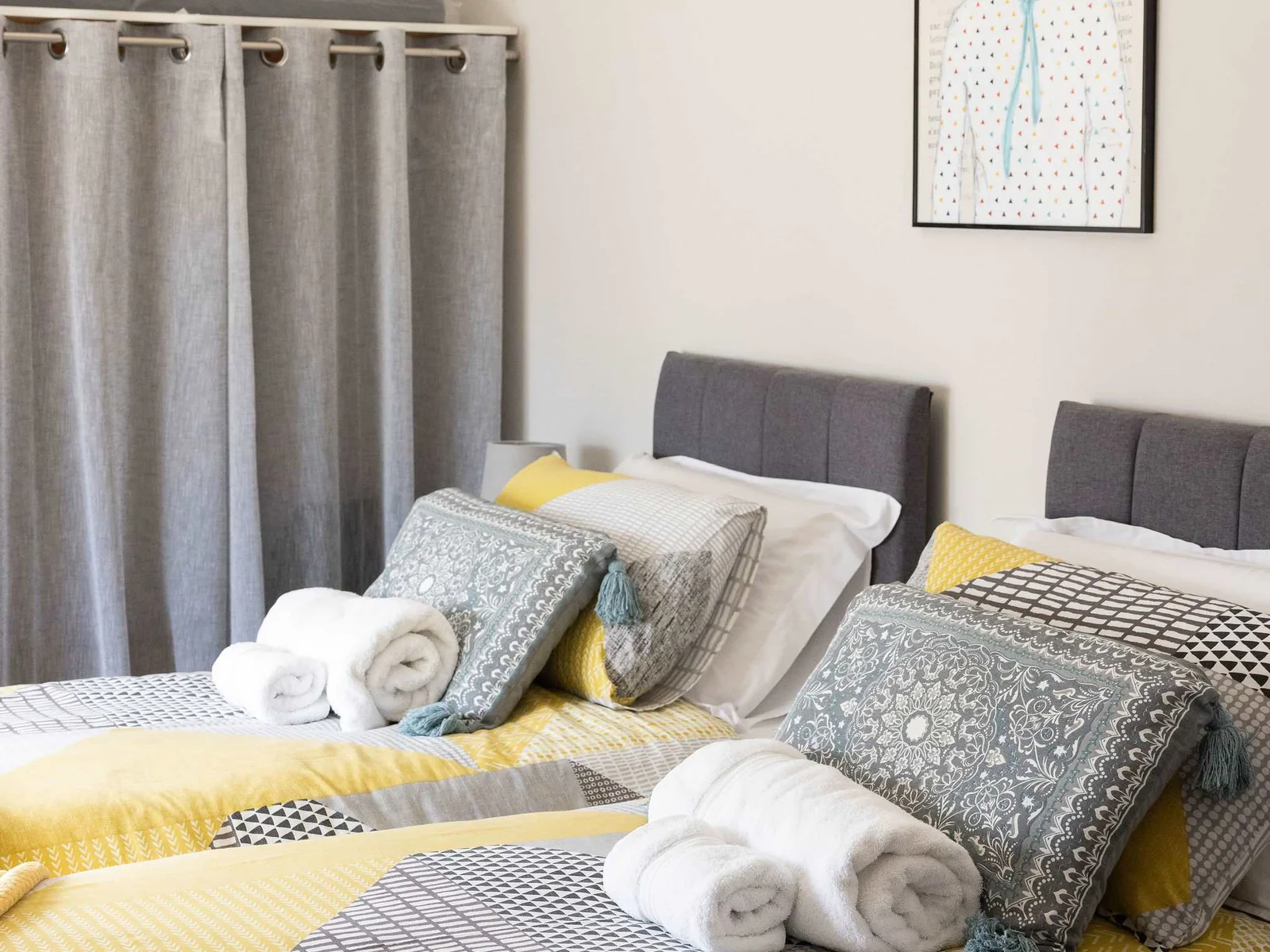 Comfortable twin bedroom with stylish décor, perfect for a relaxing family coastal retreat