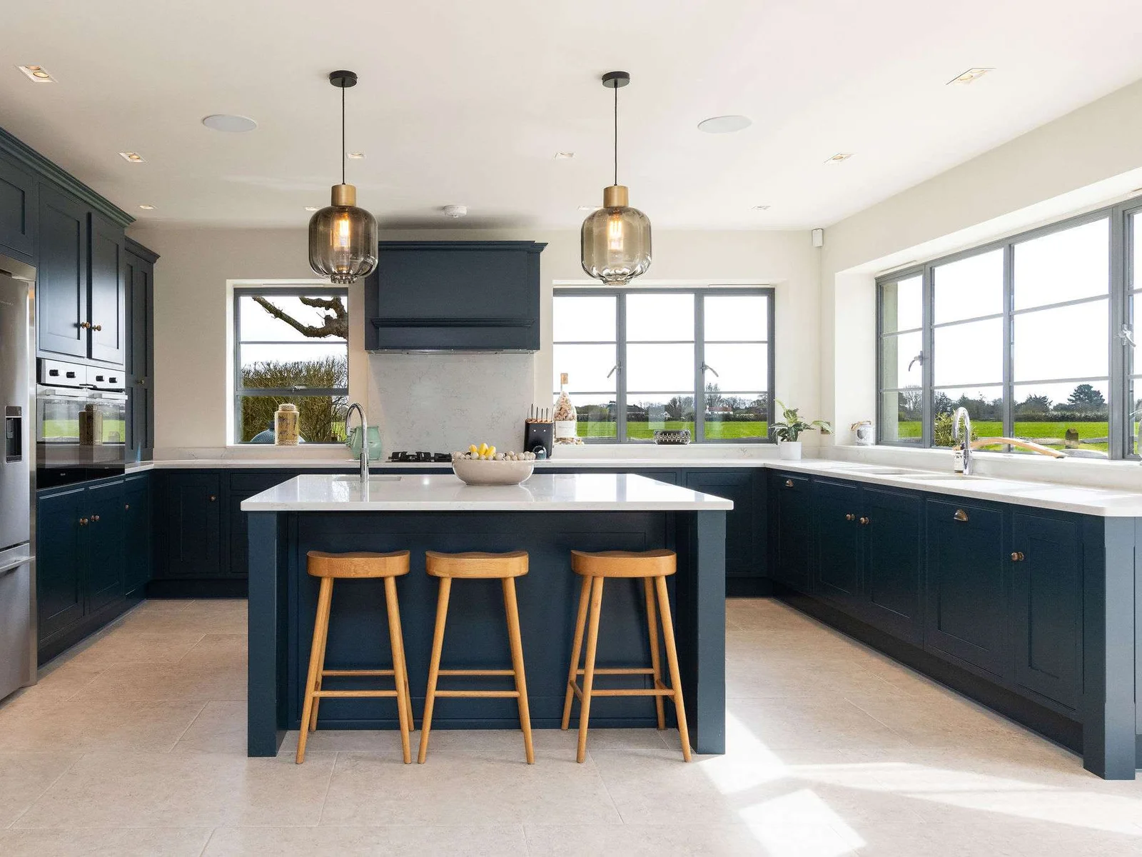 Fully equipped kitchen with stylish cabinetry, ample workspace, and natural light flooding in beautifully.