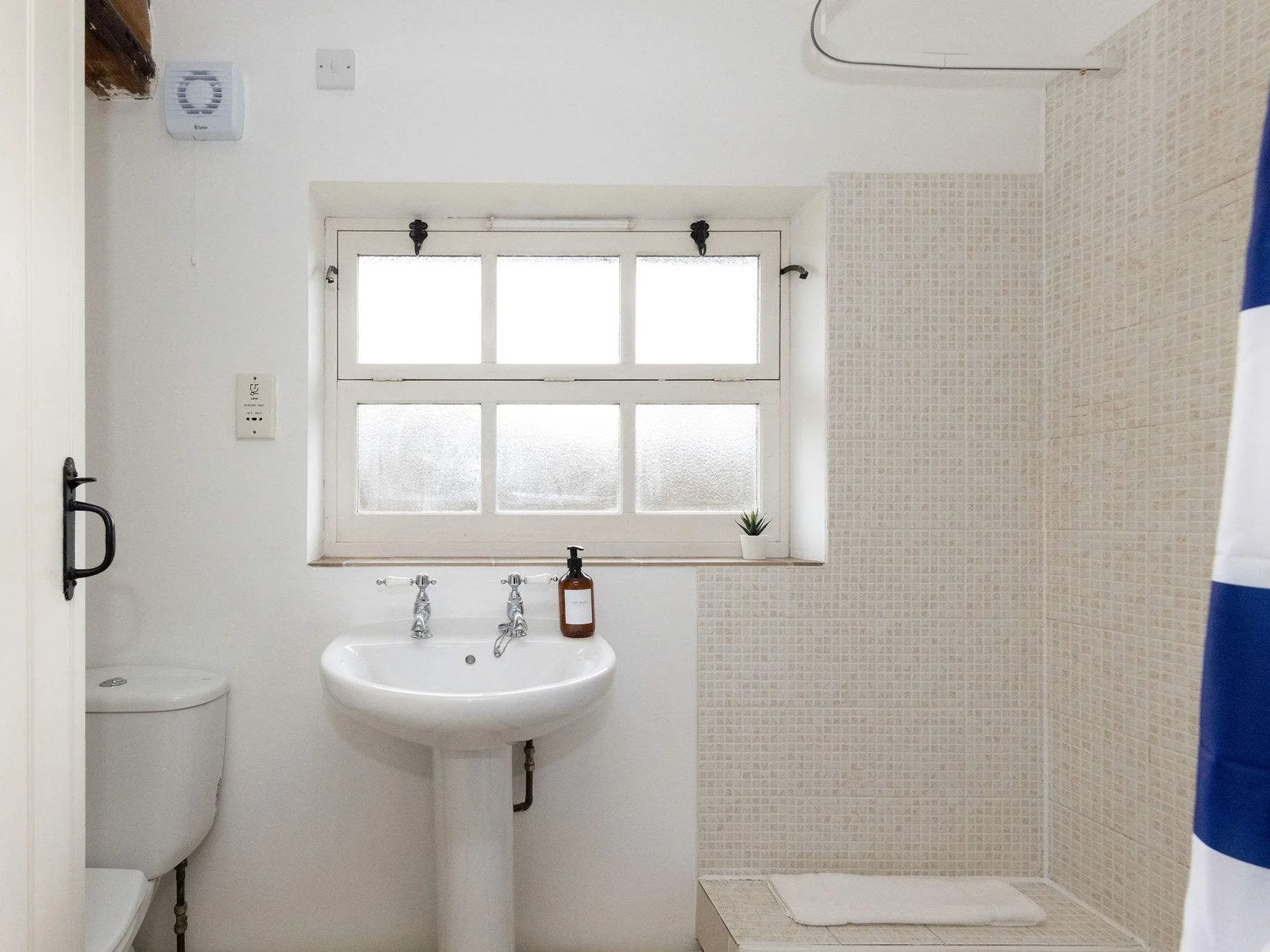 The family bathroom in The Dairy is on the ground floor and has a shower, WC and sink.