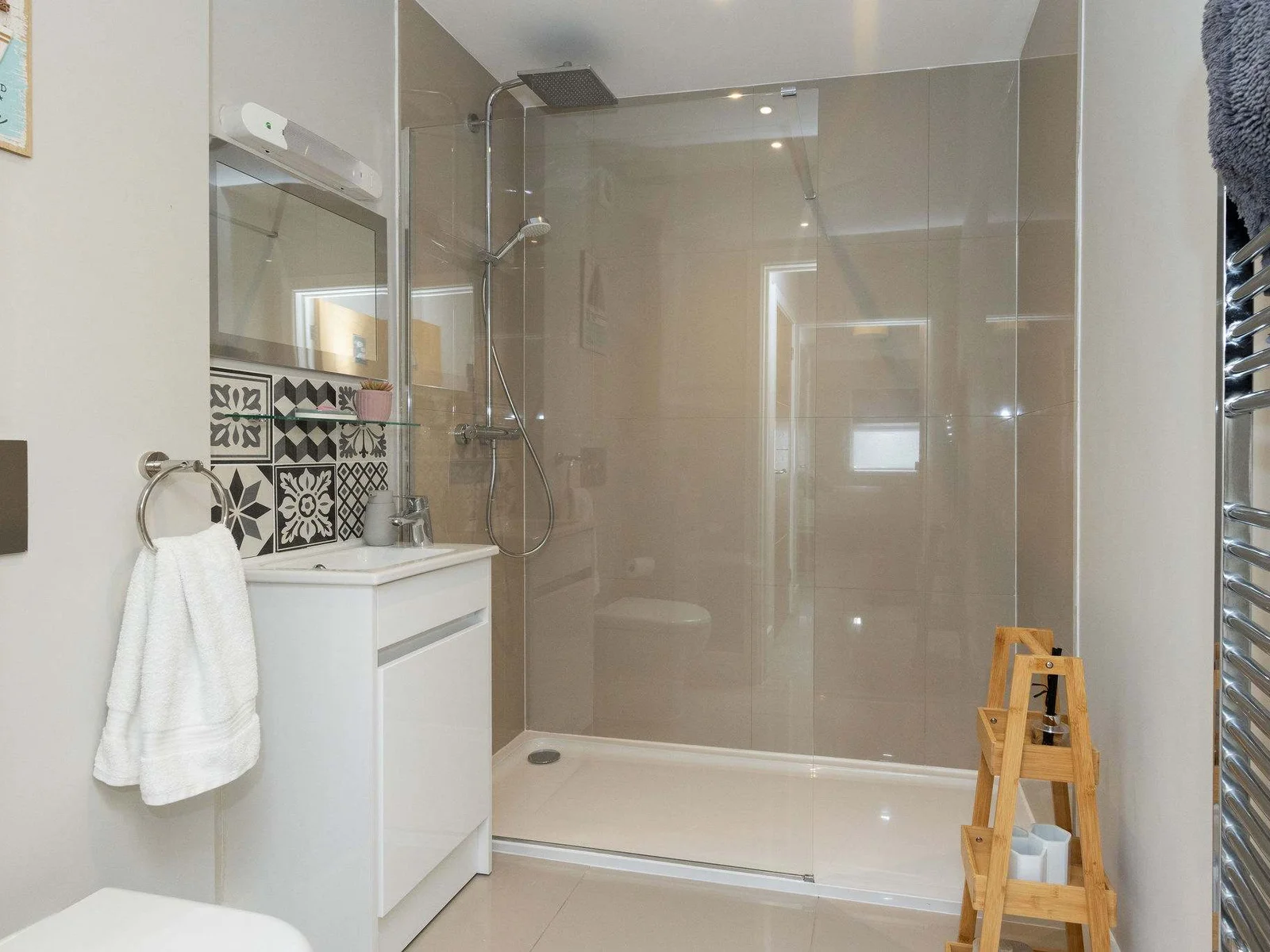Modern walk-in shower room with contemporary finishes, adding comfort to your relaxing coastal stay