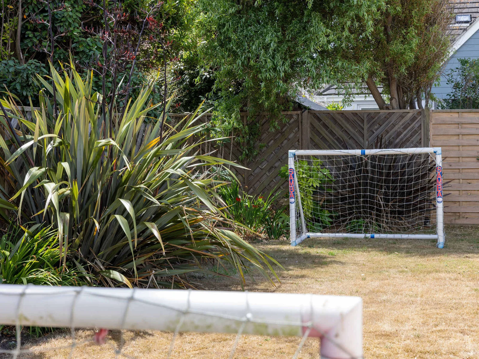 Private garden with mini football goals for kids to play
