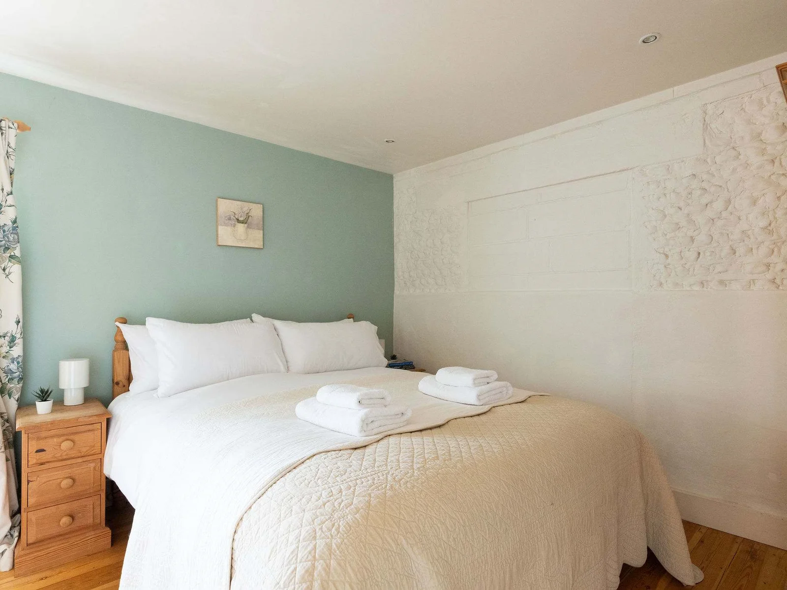 The downstairs superking in The Dairy is decorated in soft greens and creams creating a cosy cottage feel.