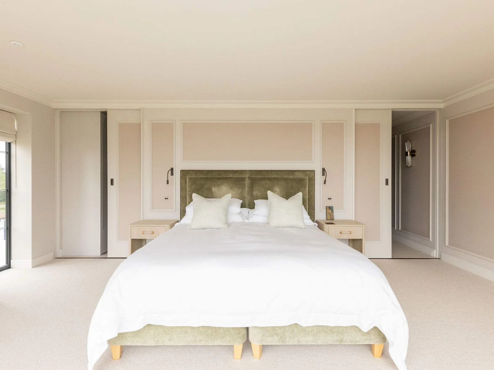 Elegant principal suite with super king bed, soft neutral tones, and balcony access