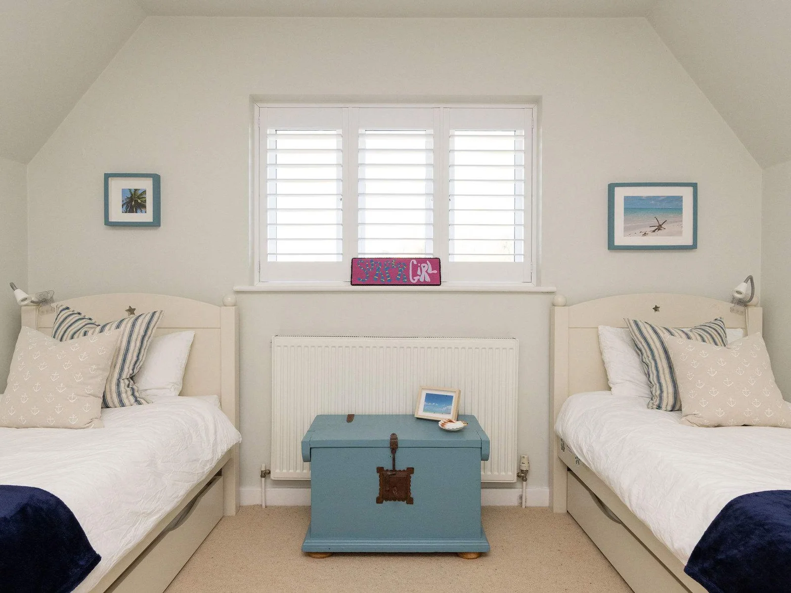 Bright twin bedroom with coastal charm.