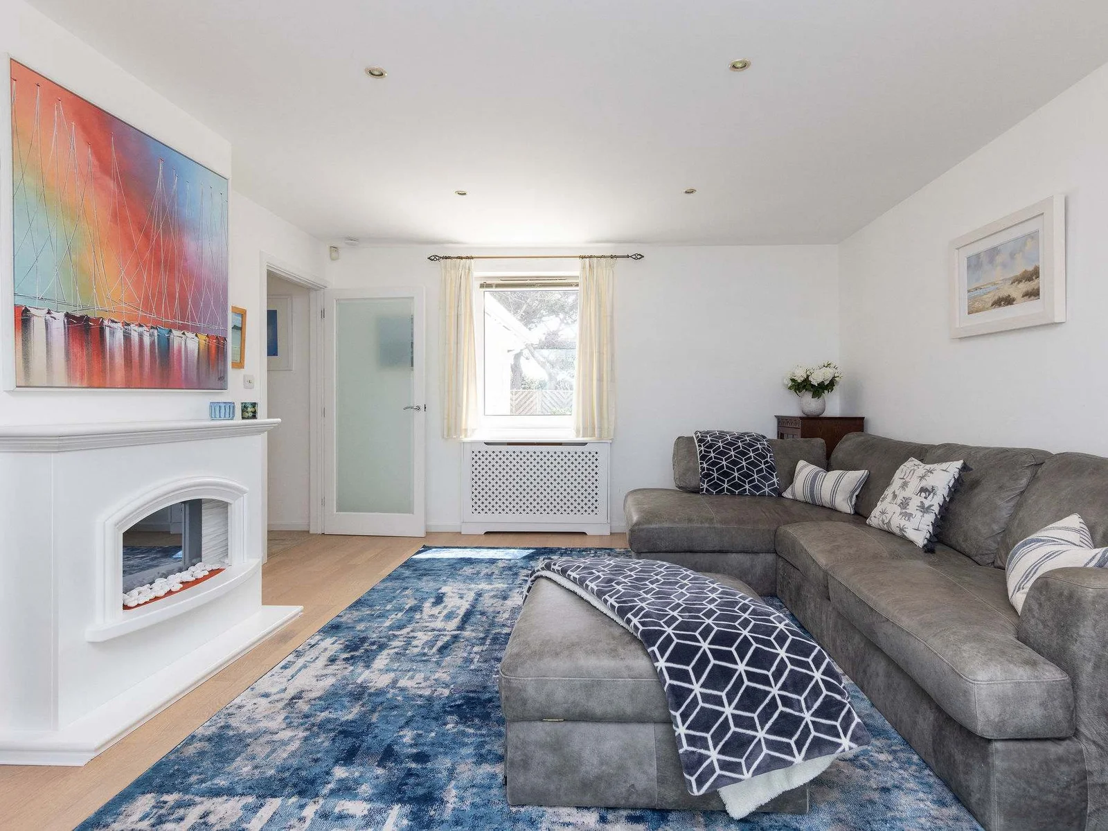 Cosy lounge with plush corner sofa and calming coastal décor.