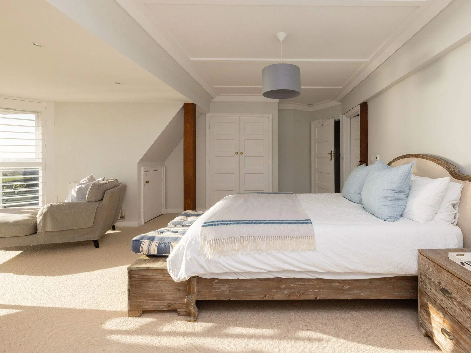 Spacious master bedroom with seating area.