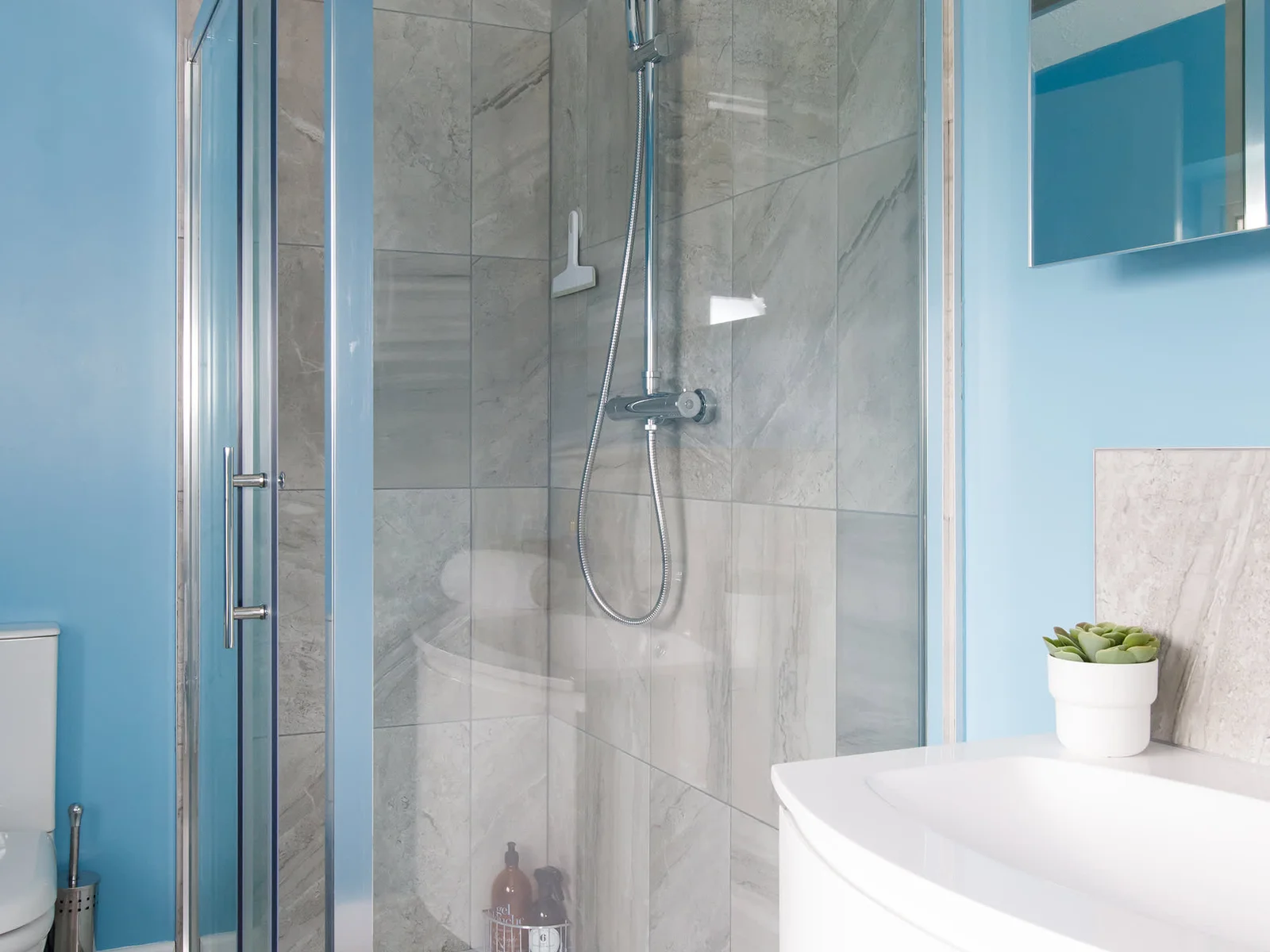 The ensuite is decorated in sky blue and stocked with fresh, white towels.