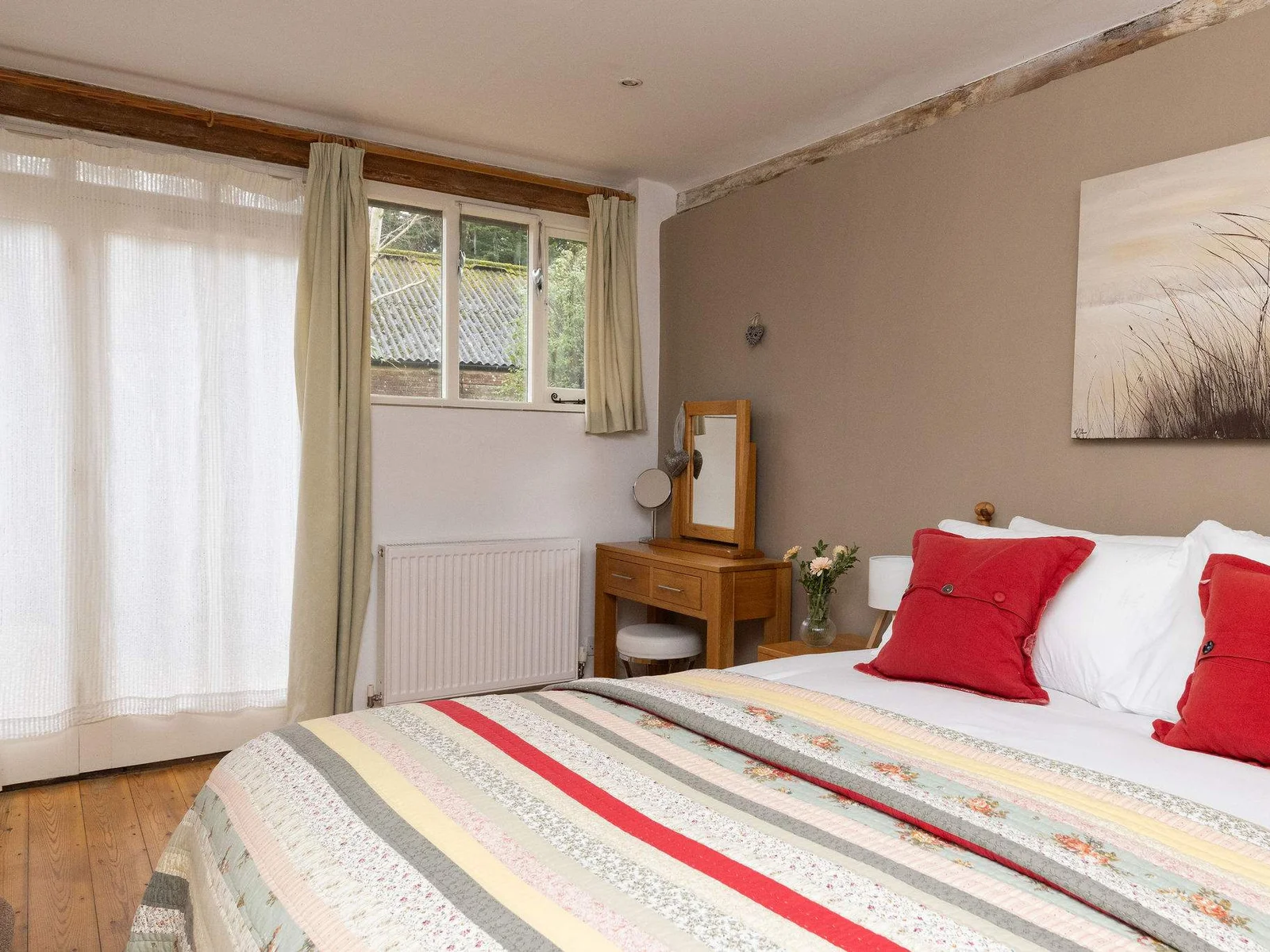 King bedroom with fresh linens, countryside views, and ensuite bathroom.