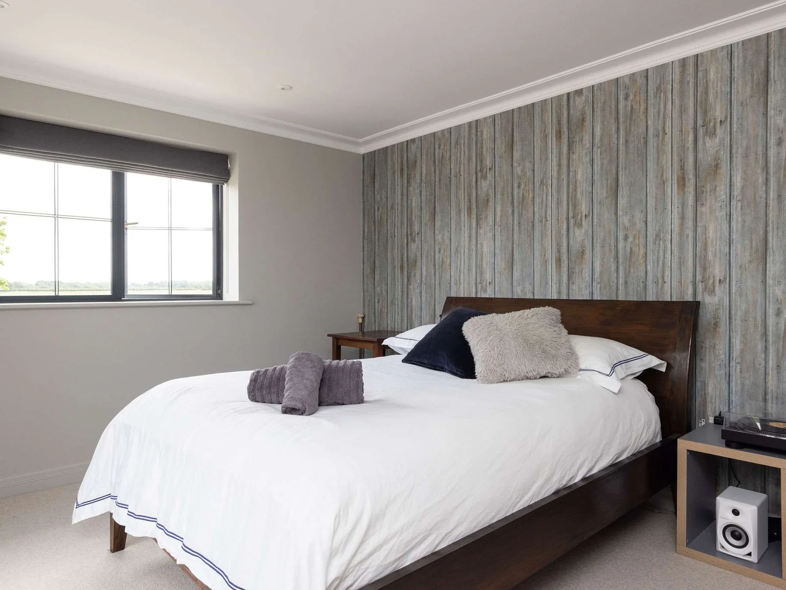 Cosy bedroom 4 with rustic wood-panelled feature wall