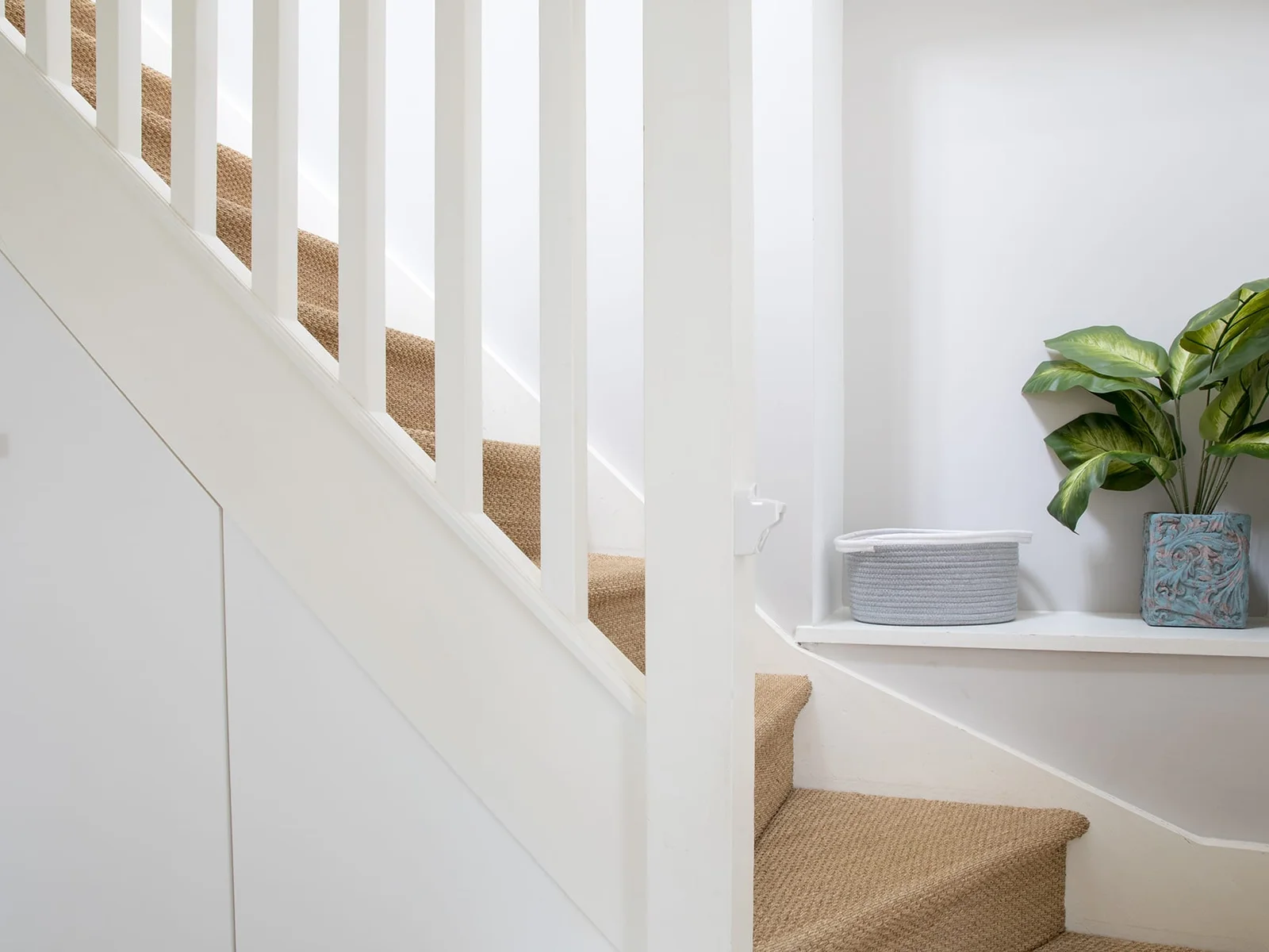 Climb up the carpeted staircase to reach the upper floor.