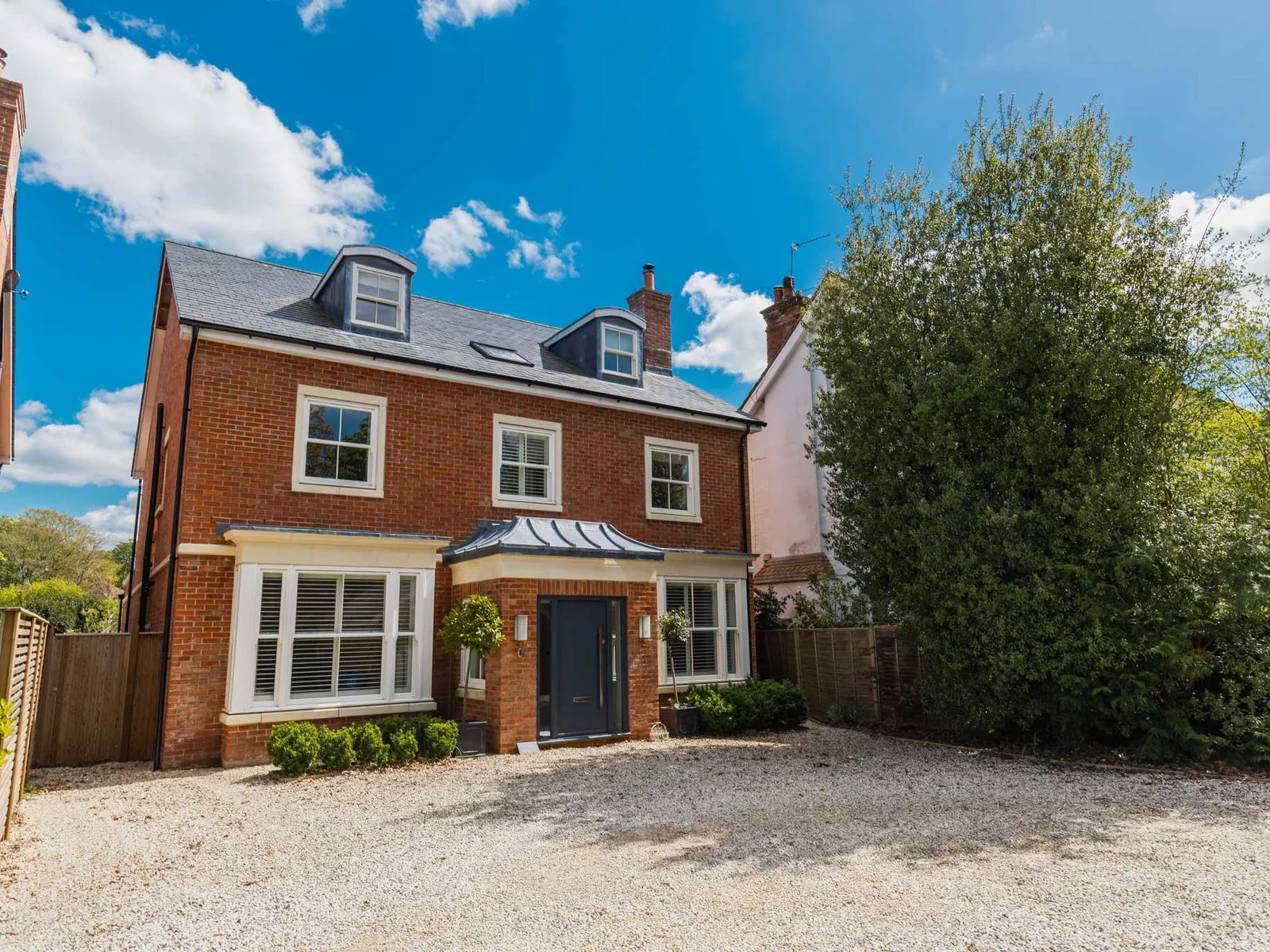 Impressive detached 6-bedroom home with private driveway parking for up to five cars.
