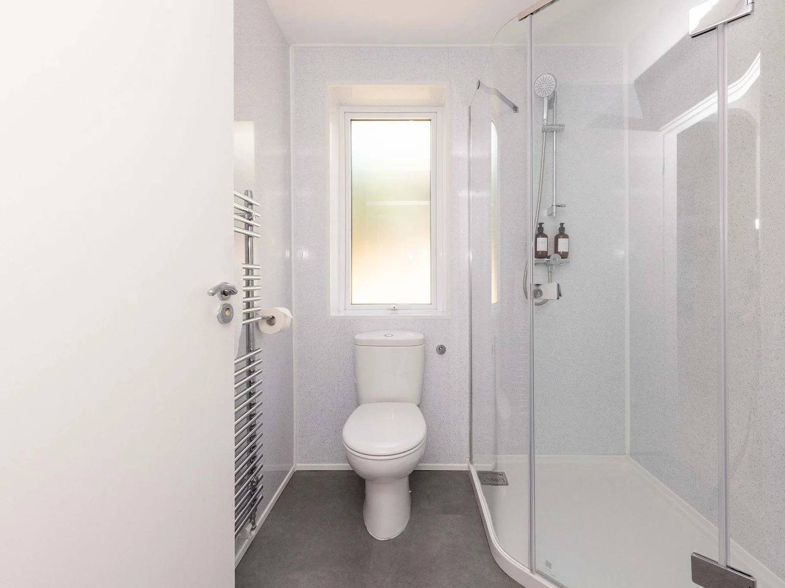 Modern shower room with heated towel rail and window