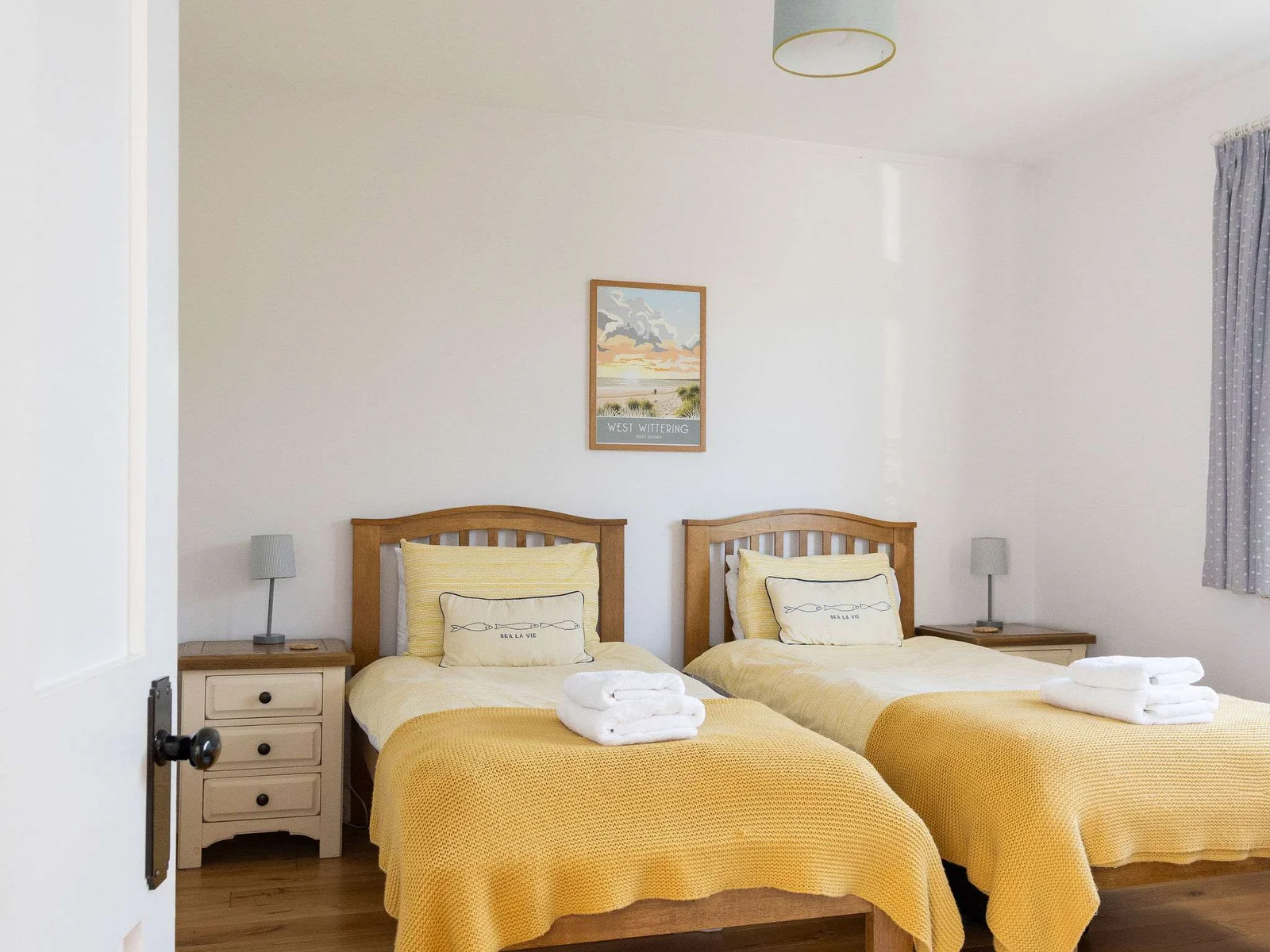 Bedroom 3 This twin bedroom offers comfortable sleeping arrangements with warm yellow accents and ample natural light. Perfect for friends or family traveling together.