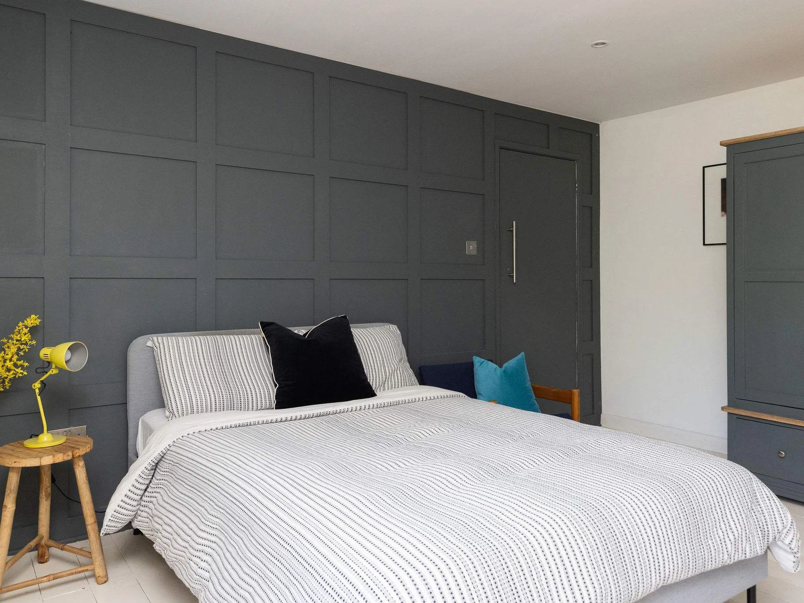 A stylish double bedroom with bold feature panelling