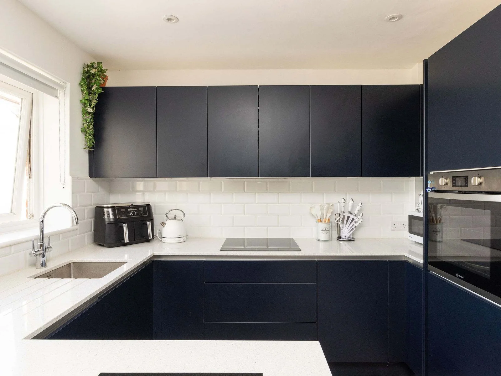 Sleek kitchen with air fryer and kettle