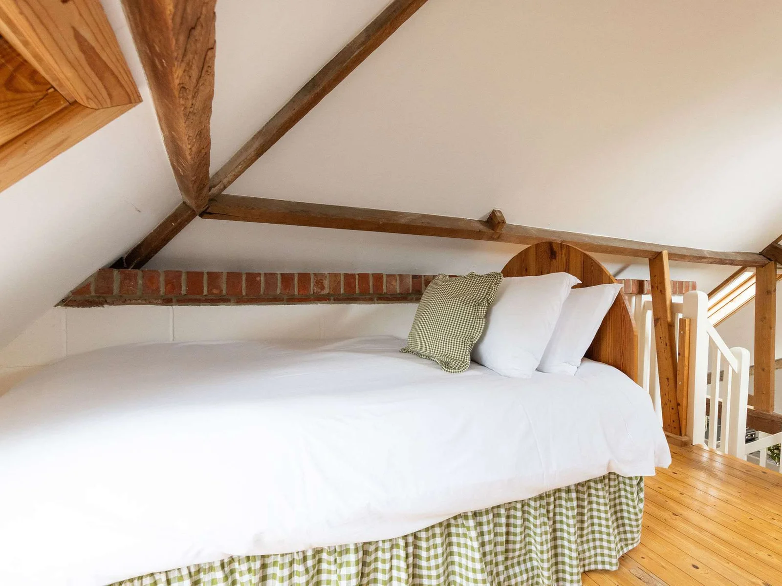 Twin bedroom with comfy beds and warm wooden tones in Wren Barn.