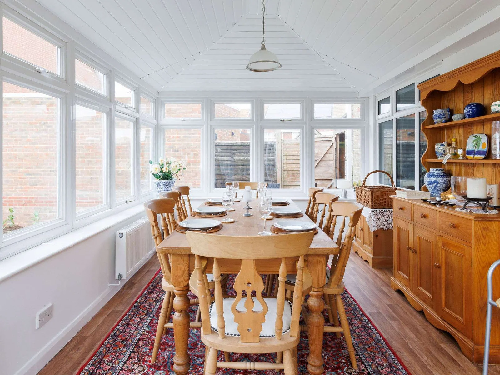 The large dining table comfortably seats 8 guests.