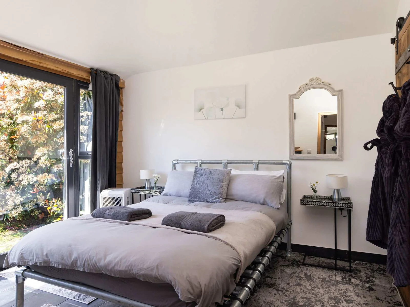 Rest easy in this stylish double bedroom featuring direct access to the beautiful outdoors.