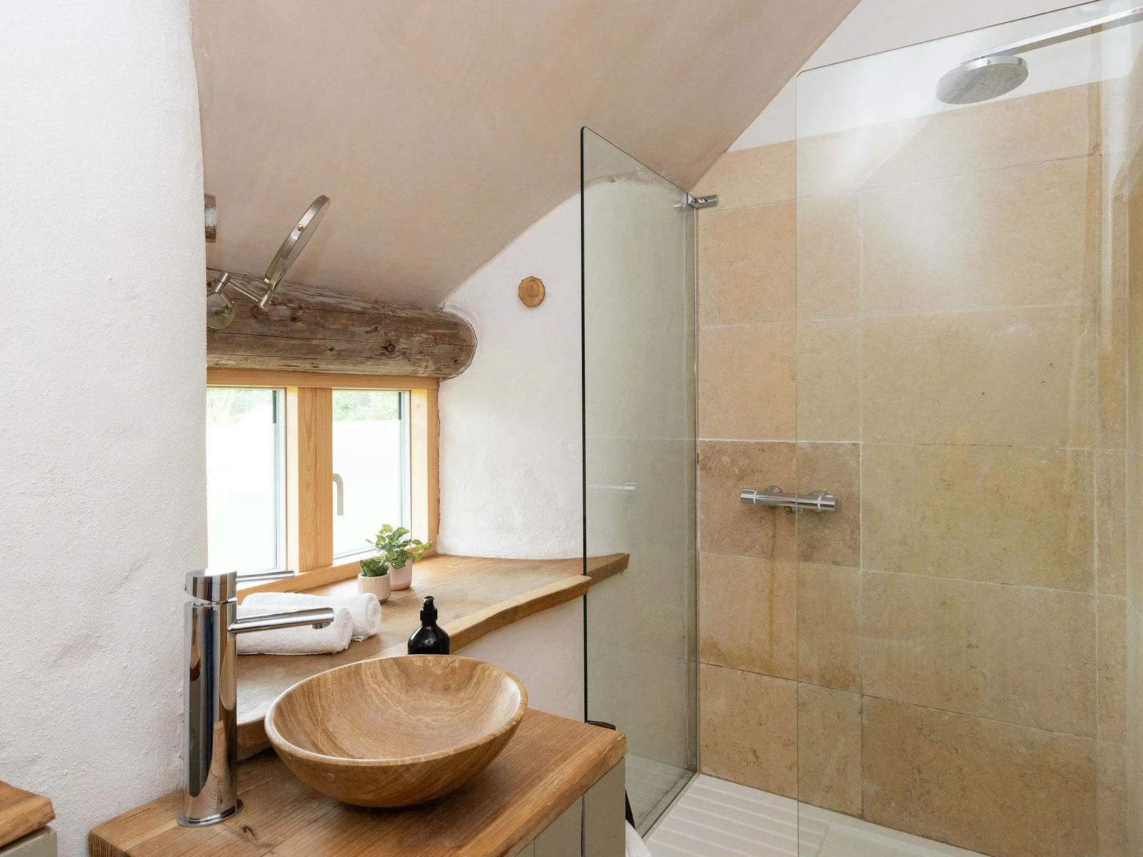 Spacious ensuite bathrooms with natural finishes — the perfect post-beach day retreat.