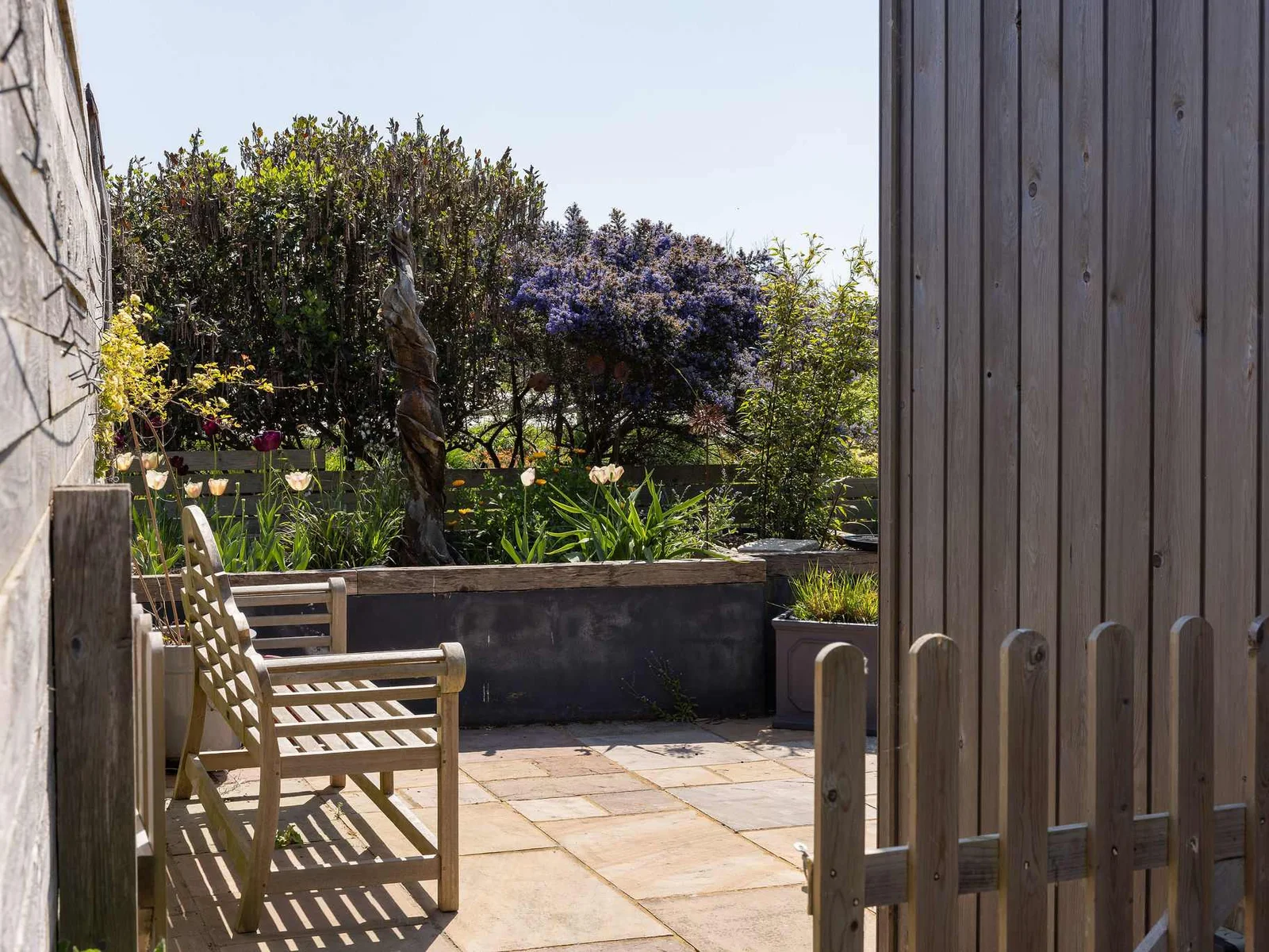 Private patio area with seating, perfect for enjoying the garden.