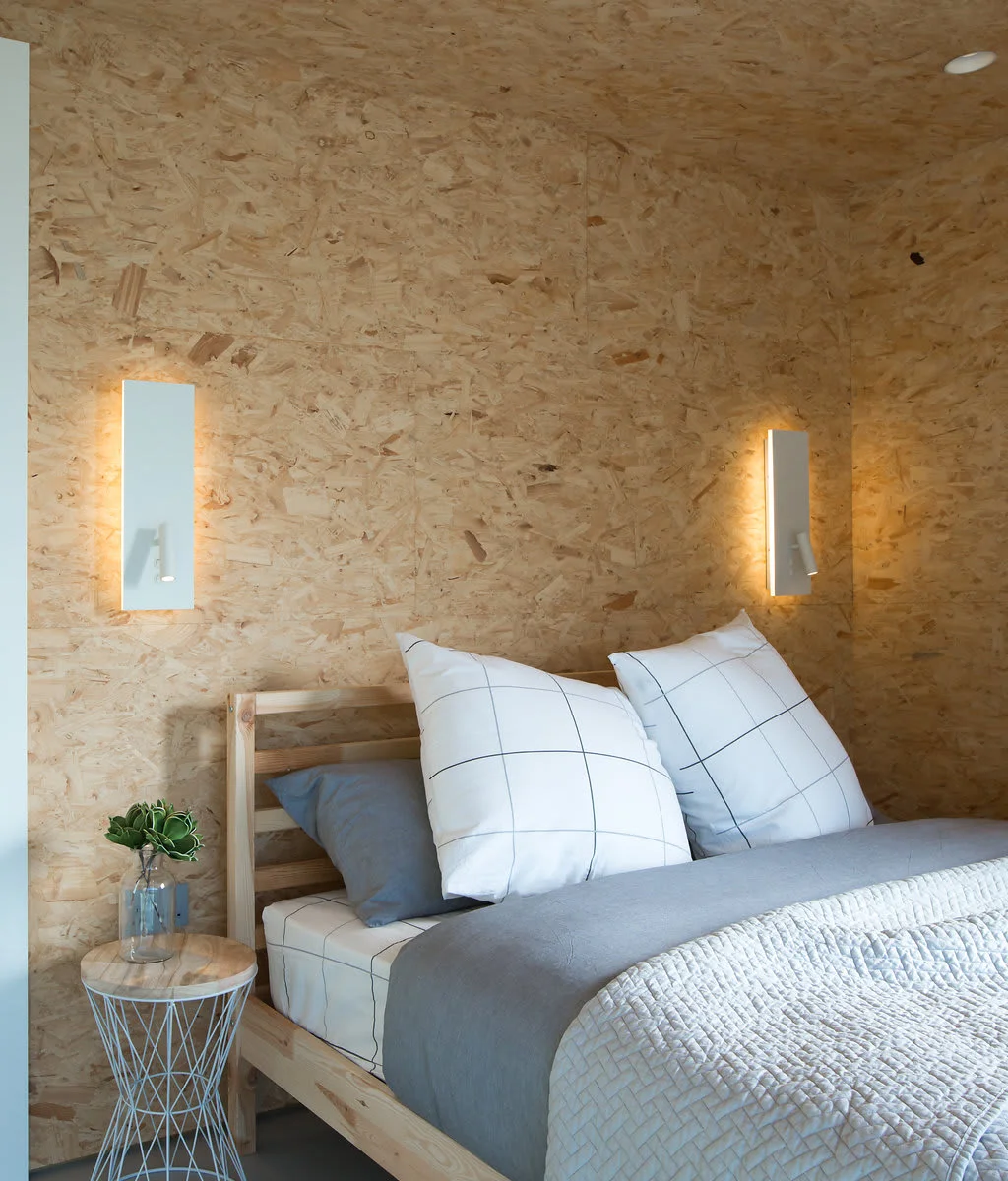 The master bedroom has a comfy king sized bed and Scandinavian style furniture.