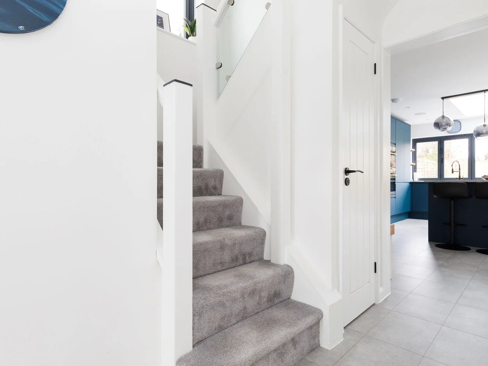 The stairs are located in the bright, airy hallway.