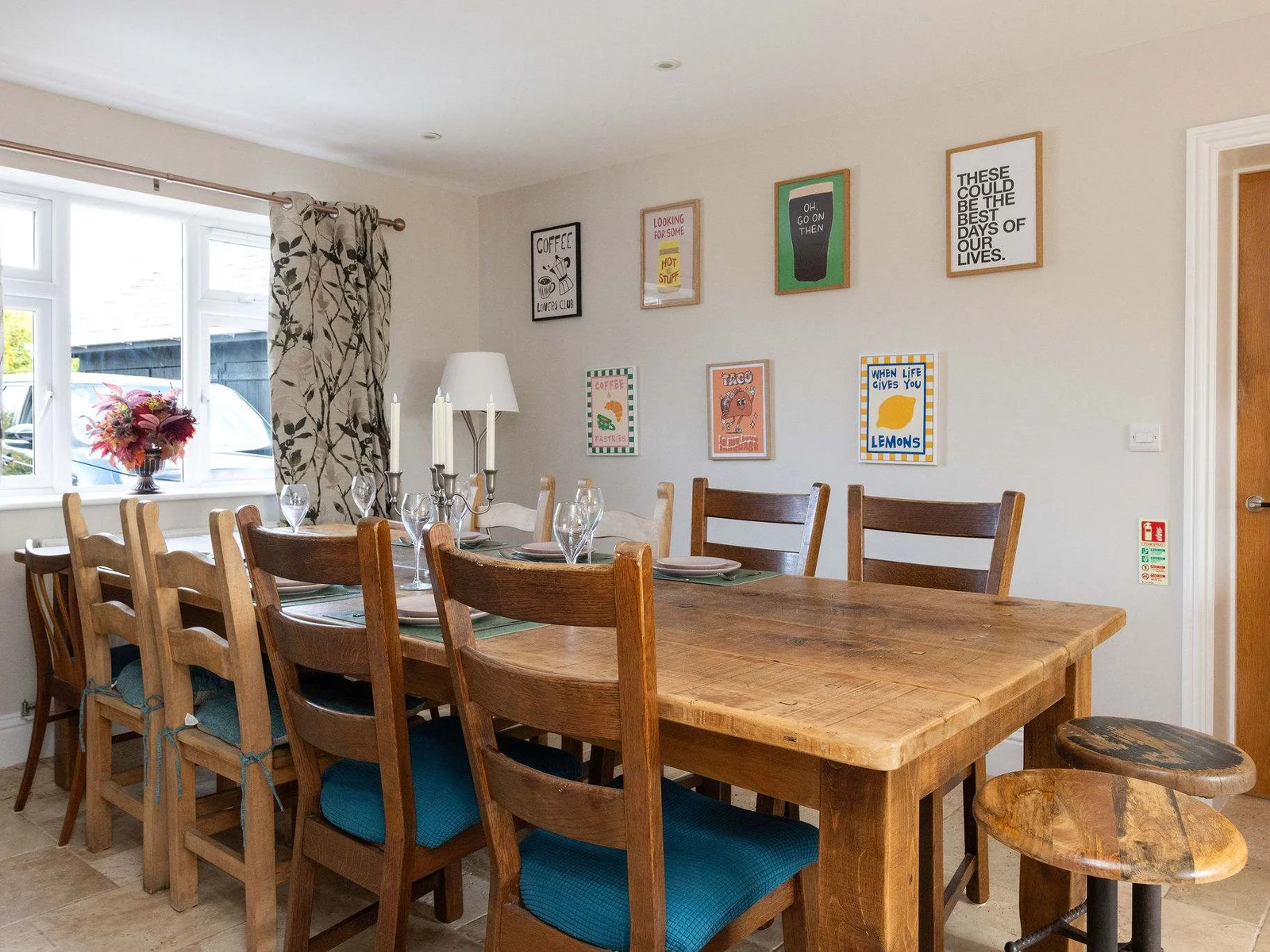 Gather around the large wooden dining table for long breakfasts, family feasts and evenings that linger — a warm, sociable space with colourful artwork and a relaxed country-house feel.