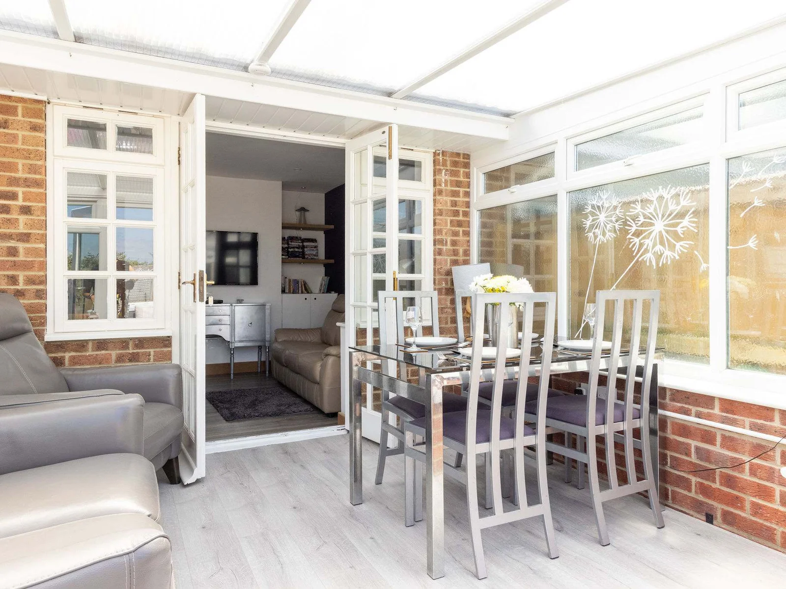 Dining space and recliners in the bright conservatory