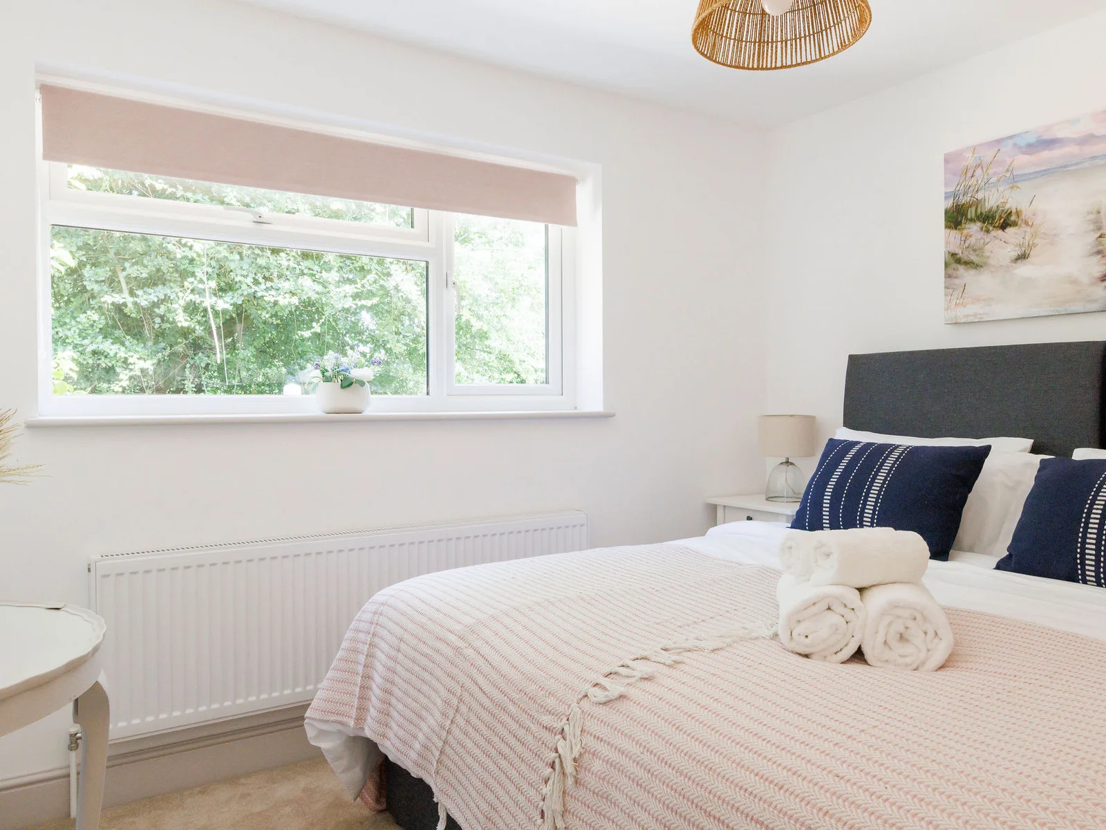 Rest easy in our cozy bedroom with a serene view and plush linens