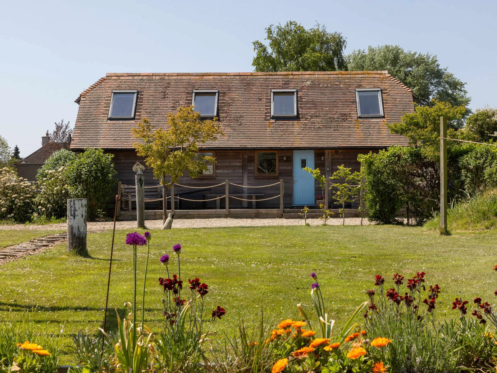 Enjoy mature gardens with flowering plants and sculptures.