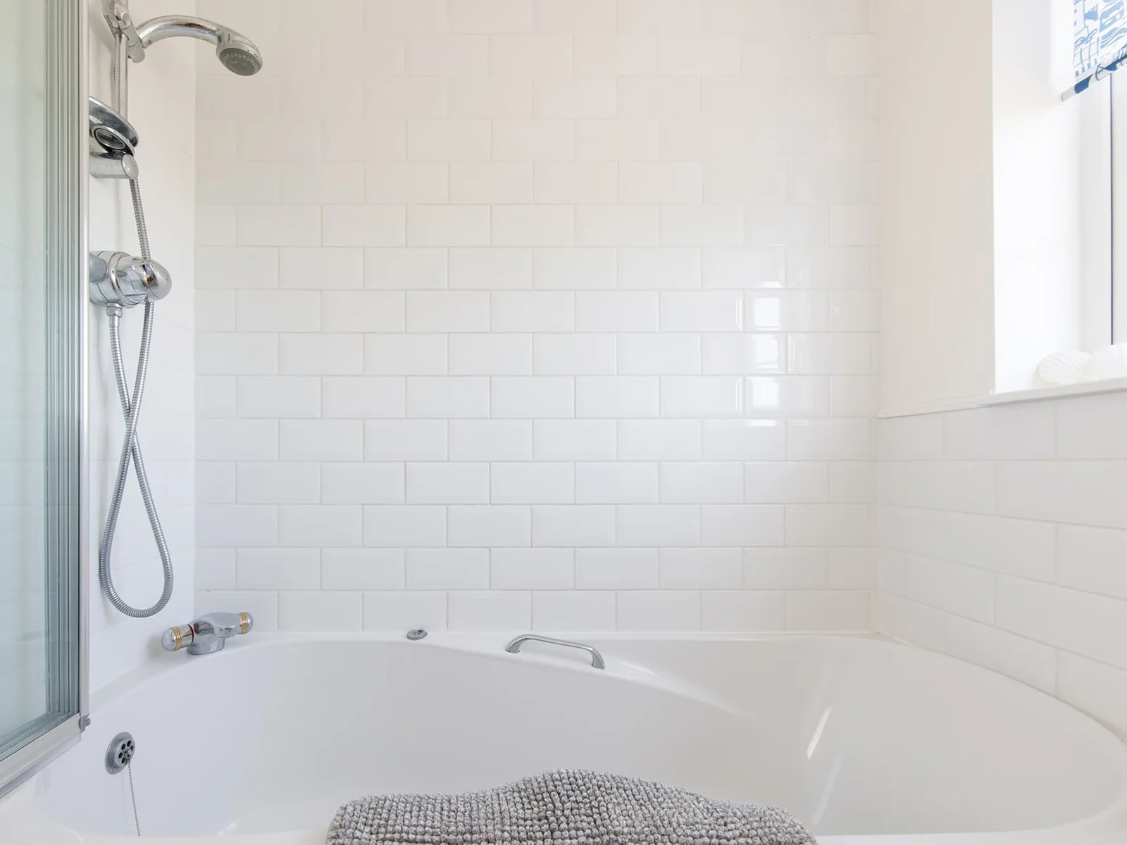 The family bathroom has a bath with overhead shower.