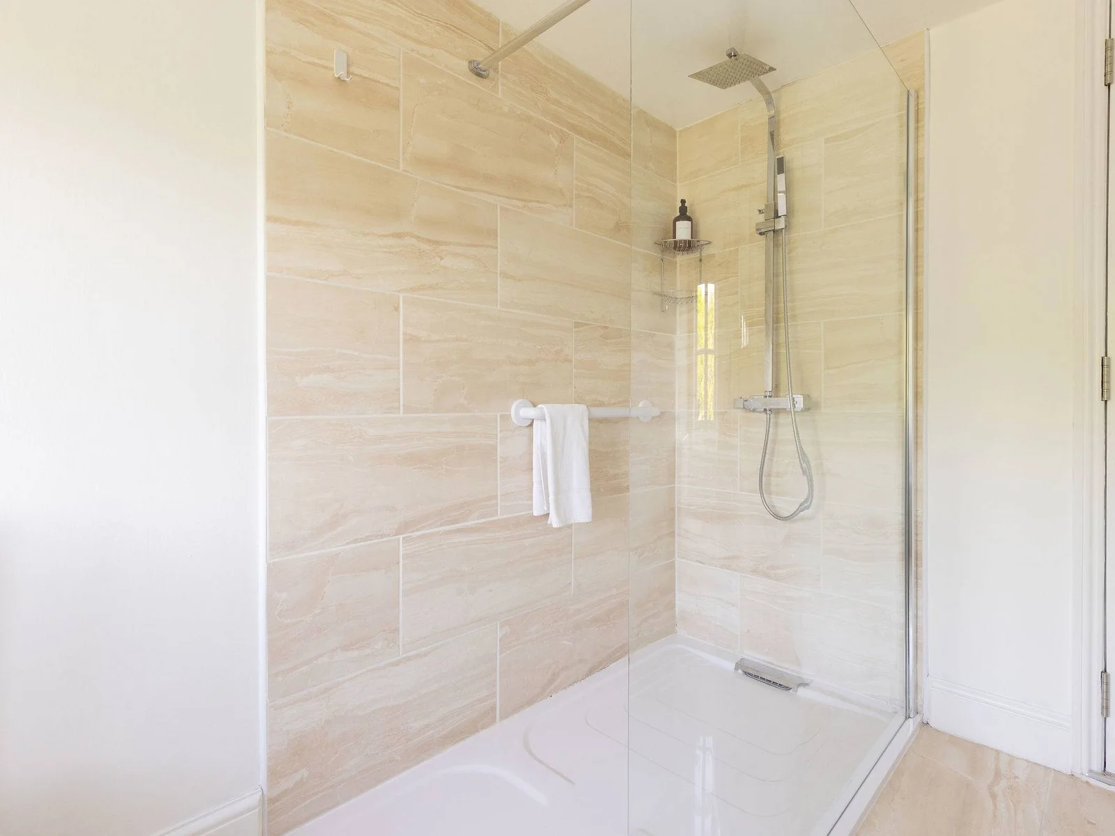 The bathroom has a large walk-in shower.