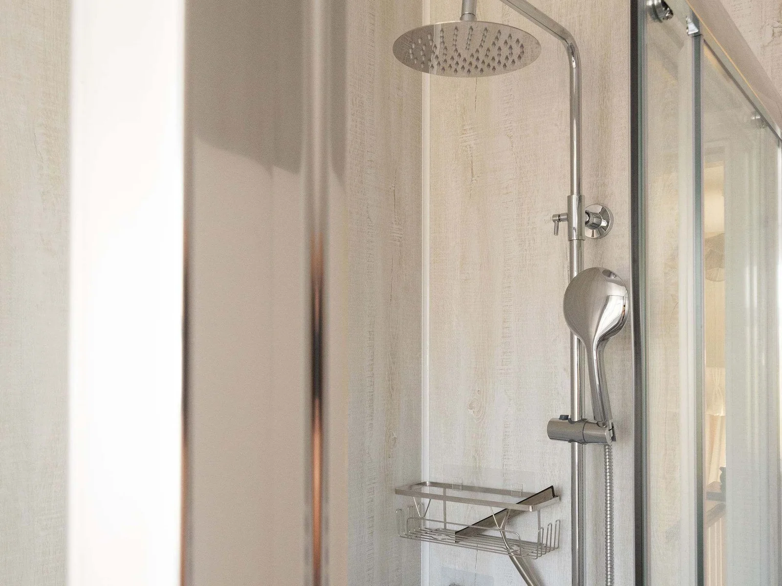 The family shower room offers a rainfall shower and handheld shower head.