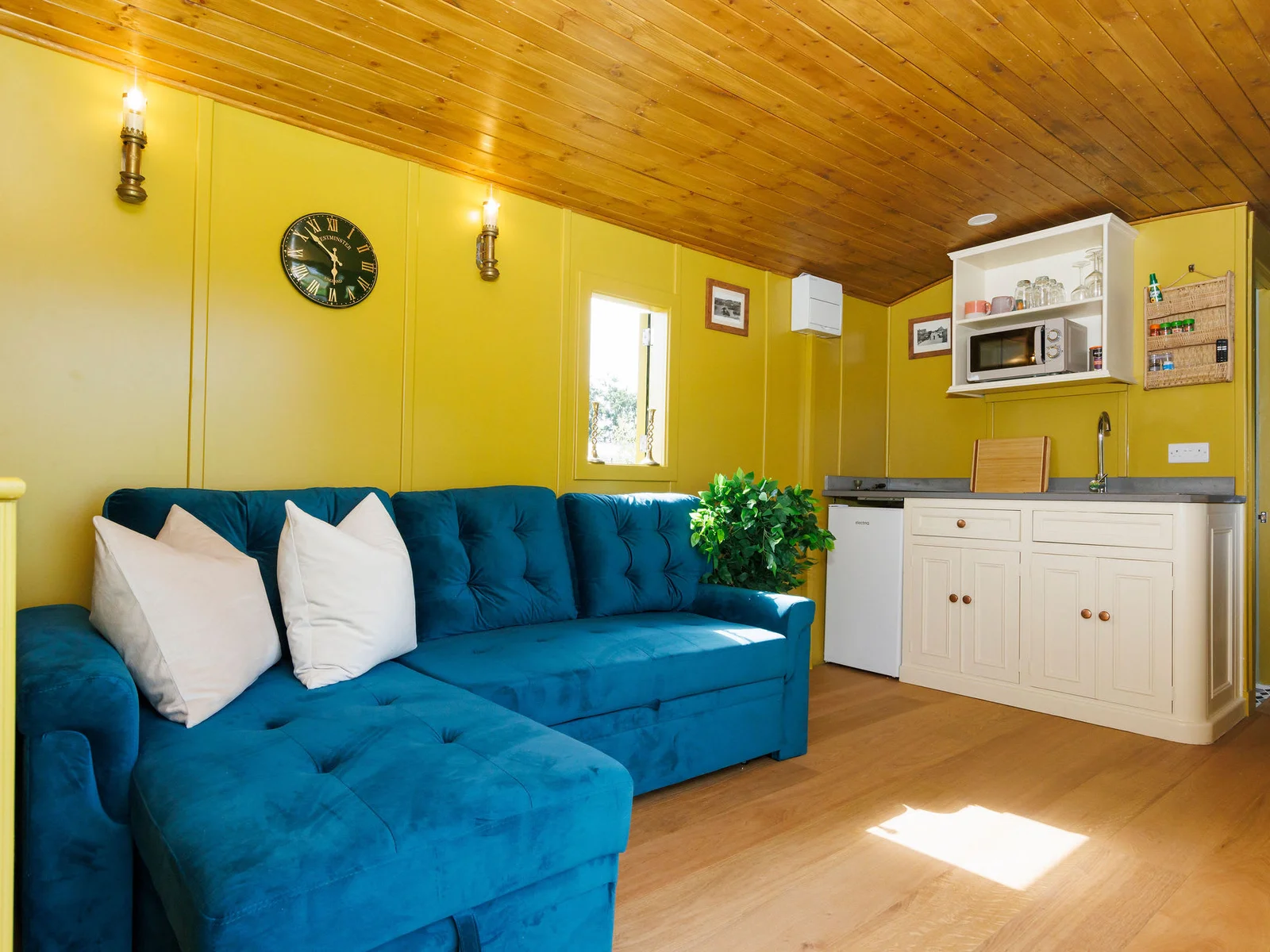 The surprisingly spacious living space has a comfortable sofa (transforms to bed for children) and well equipped kitchenette.