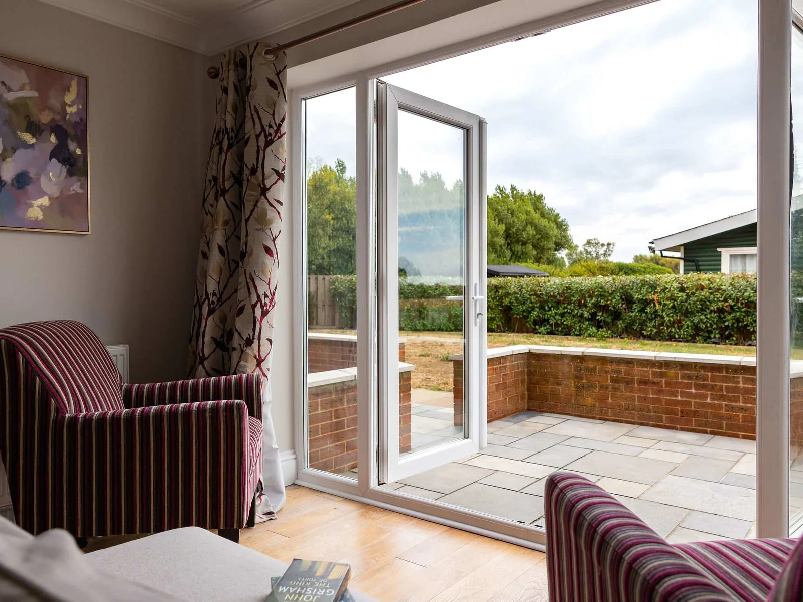Relax with a cup of tea and enjoy the natural light, with large glazed doors opening straight onto the patio and garden beyond.