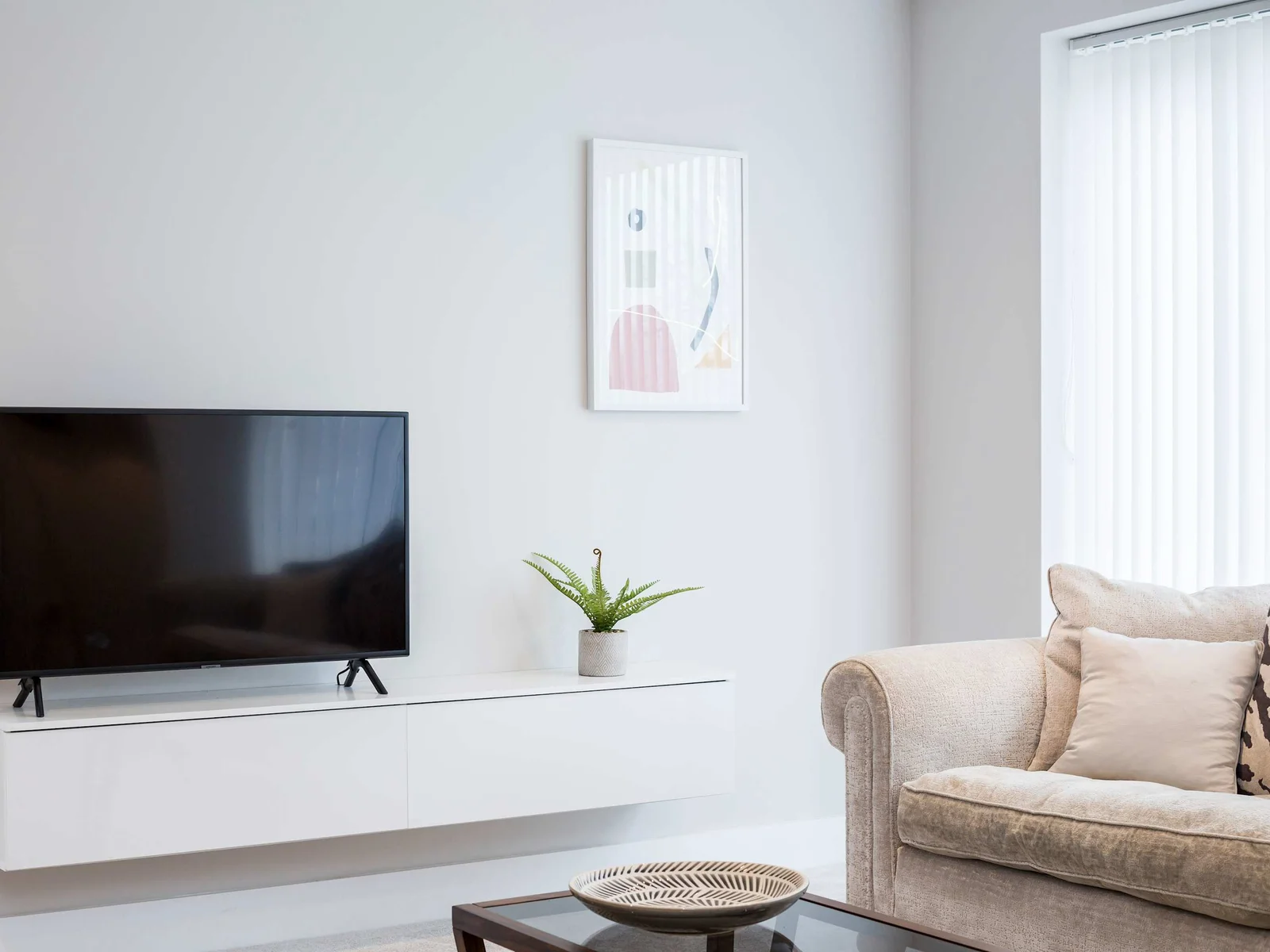 The smaller of the two lounges, featuring a sofa and flat screen TV.