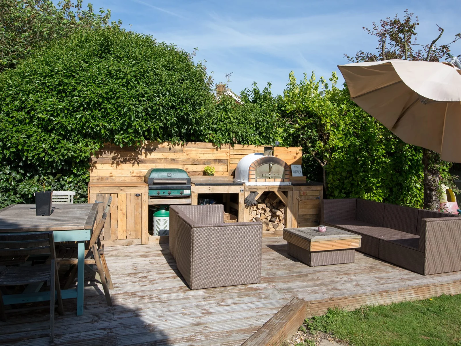 Fairy tale wooden deck in the private garden offers a sun-soaked setting for dining and relaxing. THIS BBQ HAS NOW BEEN REPLACED FOR A CHARCOAL BBQ