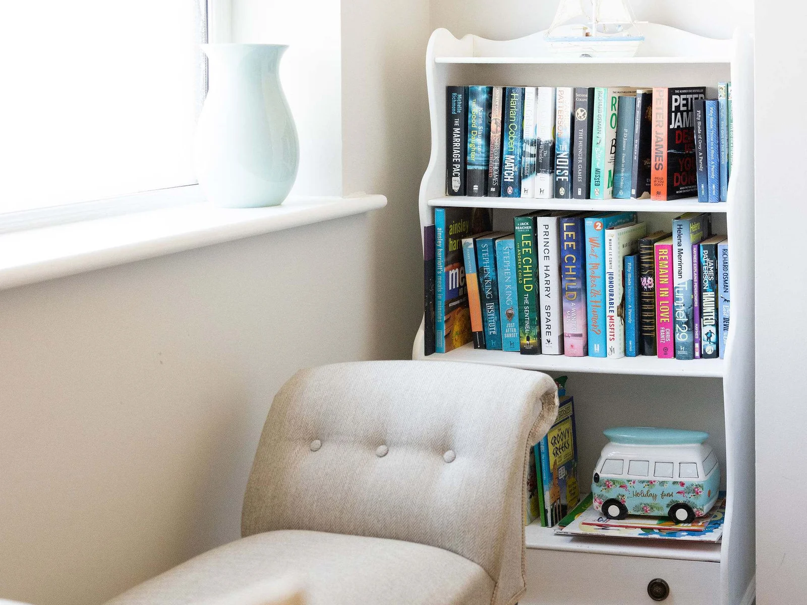 Cosy reading corner with books, creating a peaceful space to unwind during your coastal stay