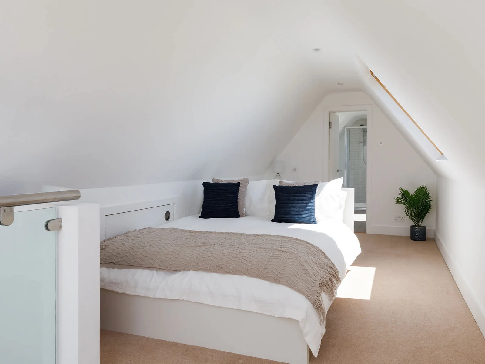 Sun-soaked loft bedroom with another ensuite bathroom
