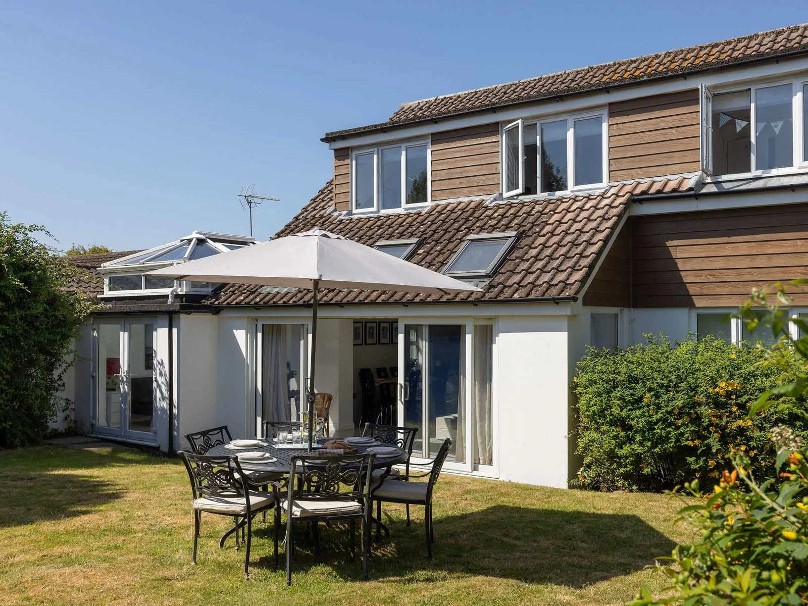 Enjoy sunny afternoons dining outdoors in the large garden of this wonderful family getaway.